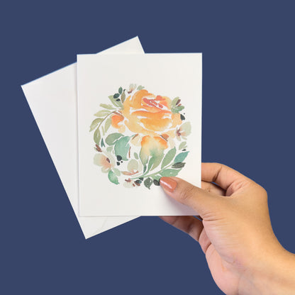 Delicate muted orange rose with white flowers greeting card